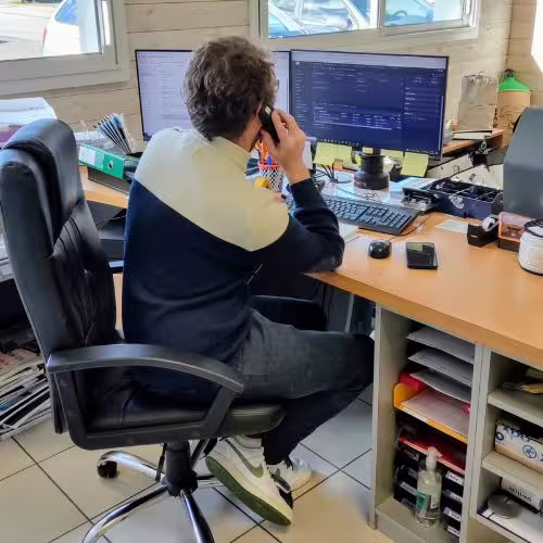 Salesman in his office on the phone